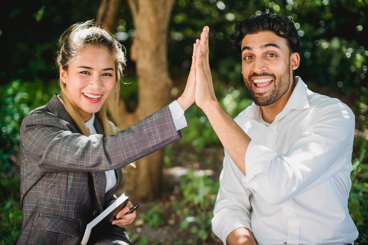 man and woman high five